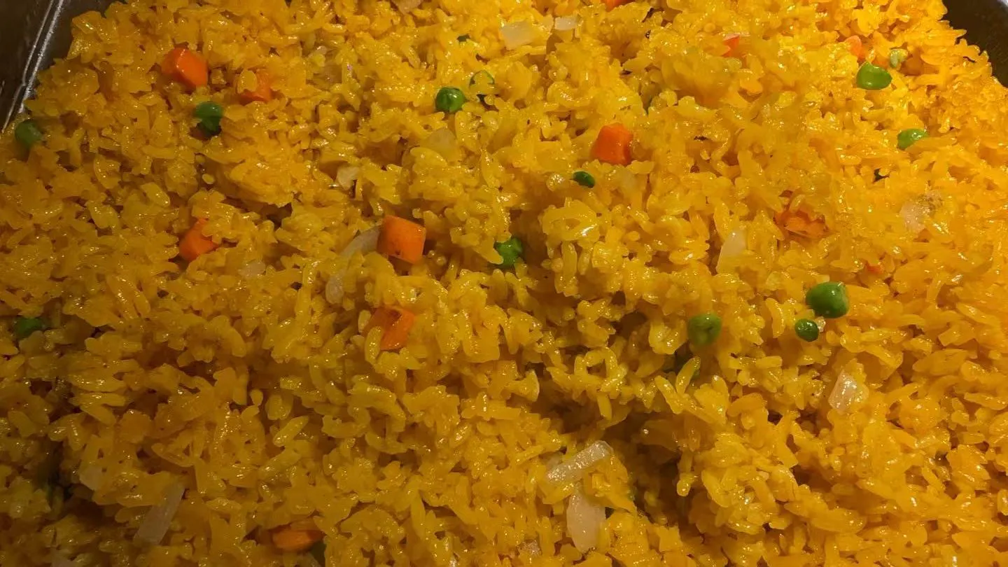 Golden yellow pineapple fried rice mixed with peas, carrots and diced onions at Sakura Buffet Restaurant in Pittsfield