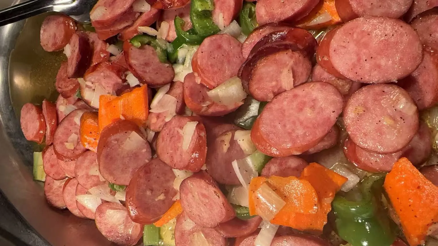 Sliced sausage stir fry mixed with bell peppers, onions and carrot wedges at Sakura Buffet Restaurant in Pittsfield