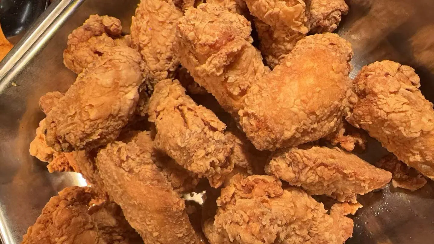 Crispy breaded fried chicken wings piled inside a metal tray at Sakura Buffet Restaurant in Pittsfield